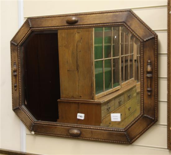 A 1920s oak octagonal wall mirror W.75cm